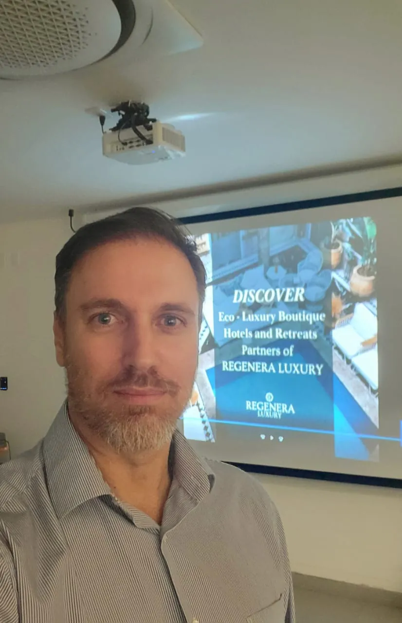 Prof. Héctor de Castro presenting in a classroom on regenerative luxury boutique hotels